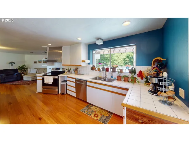 a kitchen with stainless steel appliances kitchen island granite countertop a sink and cabinets