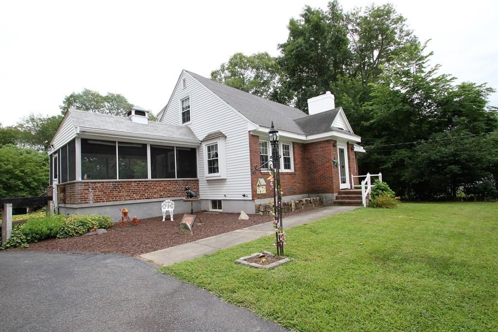 43 Higley Road Ashland, MA 01721 - Photo 2 of 28 a front view of a house with a yard and trees