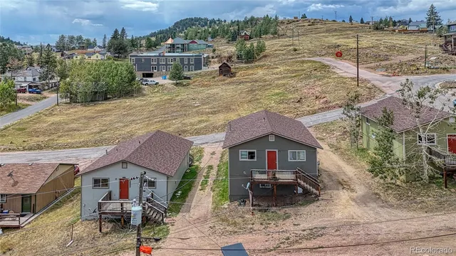 an aerial view of a house with a yard and lake view