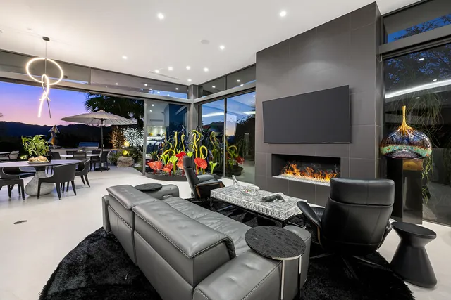 a living room with fireplace furniture and a flat screen tv