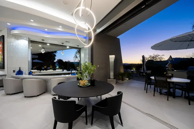 a view of a dining room with furniture and chandelier