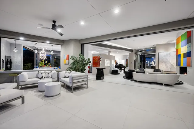 a living room with lots of furniture and kitchen view