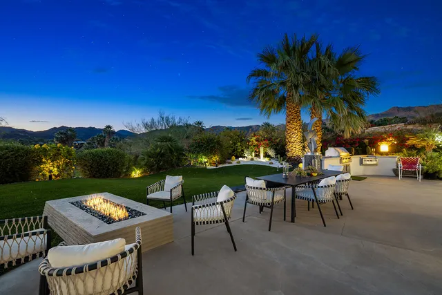 a view of a swimming pool and lounge chairs
