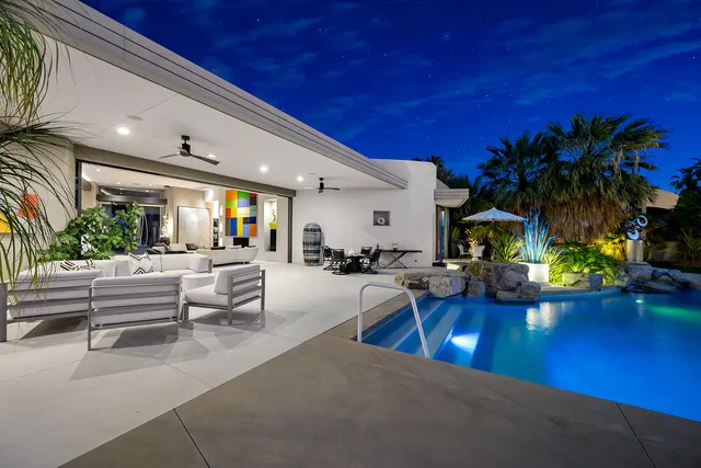 a view of a house with swimming pool and porch with furniture