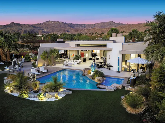 a view of a swimming pool with a table and chairs