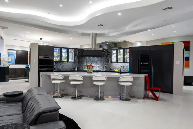 a bedroom with a bed and a mirror with a dresser