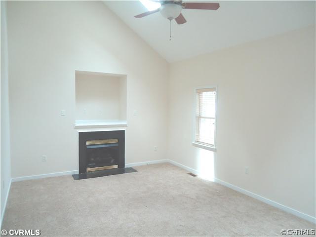 3925 Hazelnut Branch Road Midlothian, VA 23112 - Photo 4 of 15 an empty room with a fireplace and windows