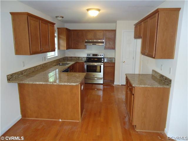 3925 Hazelnut Branch Road Midlothian, VA 23112 - Photo 5 of 15 a kitchen with granite countertop wood cabinets and stainless steel appliances