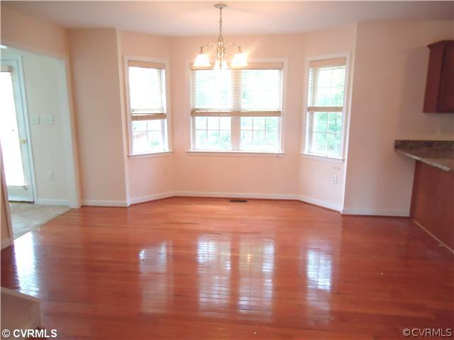 3925 Hazelnut Branch Road Midlothian, VA 23112 - Photo 6 of 15 an empty room with wooden floor and windows
