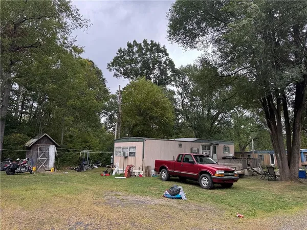 a front view of a house with a garden and parking space