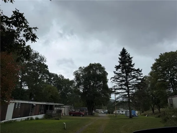 a backyard of a house with lots of green space and fountain