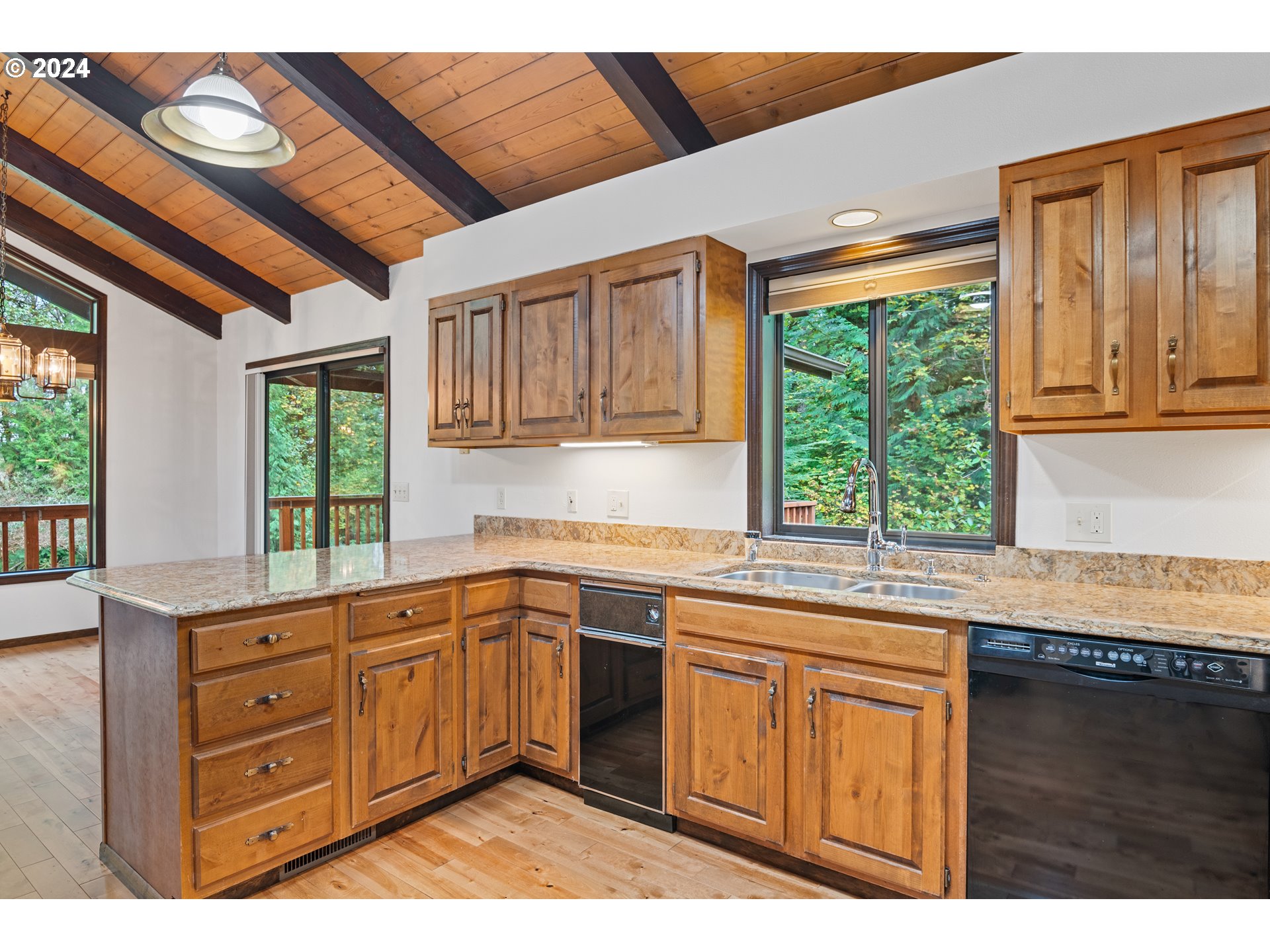 209 Car Road Longview, WA 98632 - Photo 11 of 40 a kitchen with a sink window and cabinets
