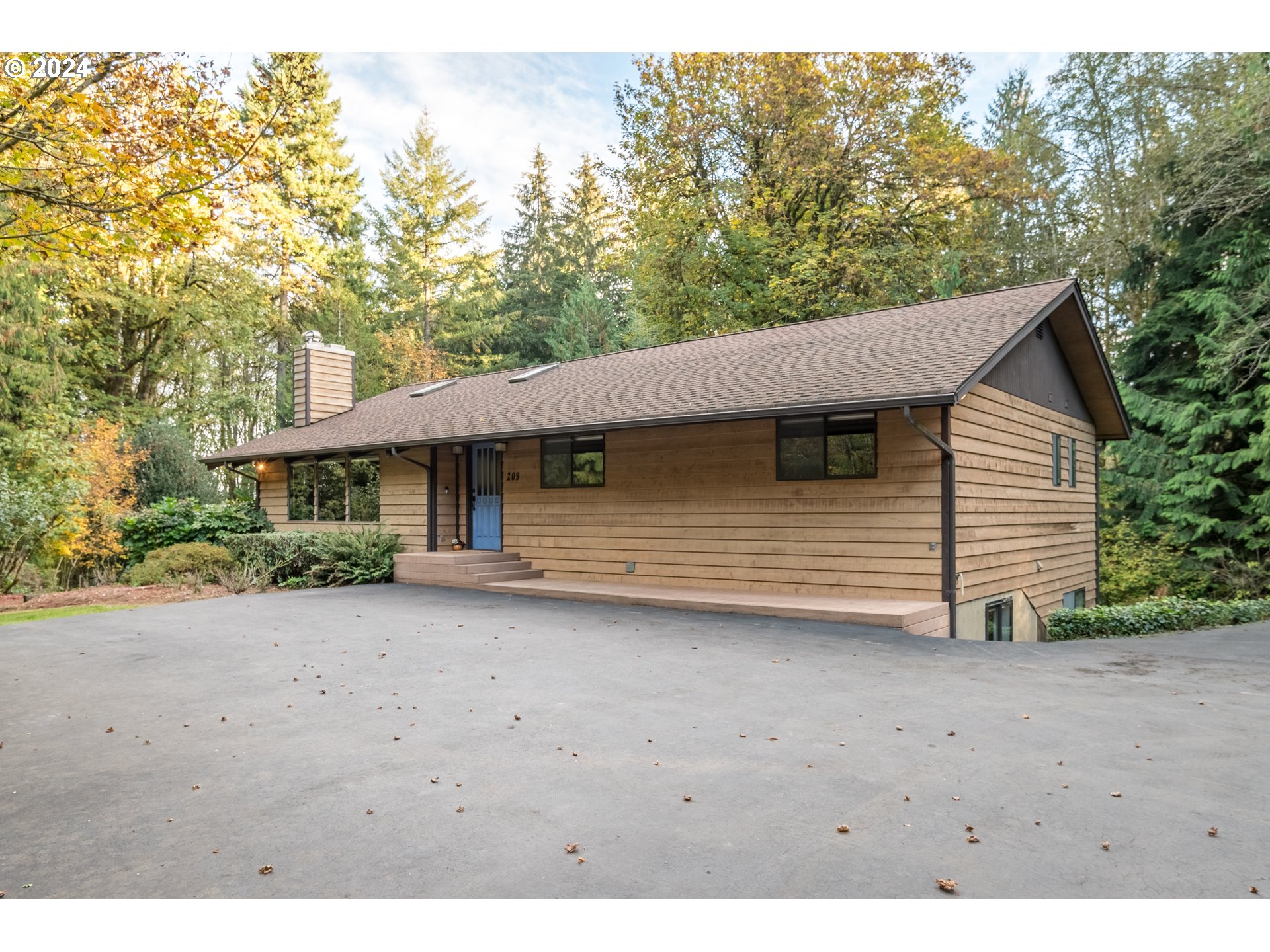 209 Car Road Longview, WA 98632 - Photo 2 of 40 a view of a house with a backyard and bushes