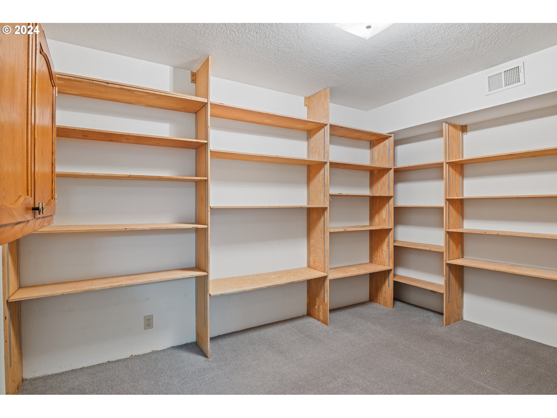 209 Car Road Longview, WA 98632 - Photo 25 of 40 a room with walk in closet and wooden shelves