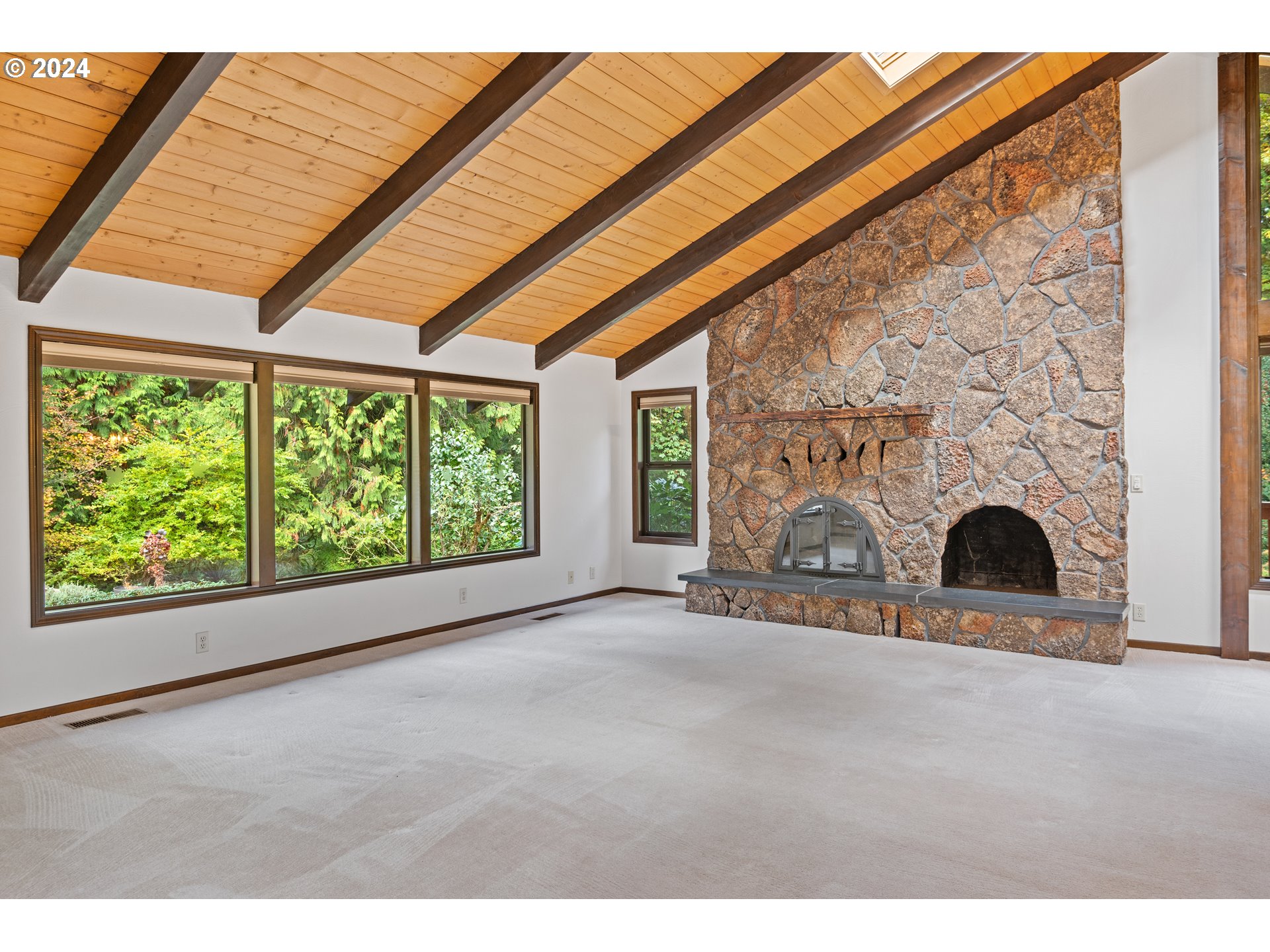 209 Car Road Longview, WA 98632 - Photo 8 of 40 a view of an empty room with a fireplace and a window