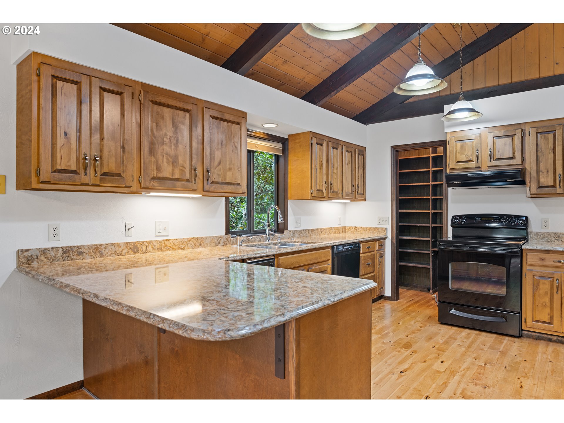 209 Car Road Longview, WA 98632 - Photo 10 of 40 a kitchen with kitchen island granite countertop a sink cabinets and stainless steel appliances