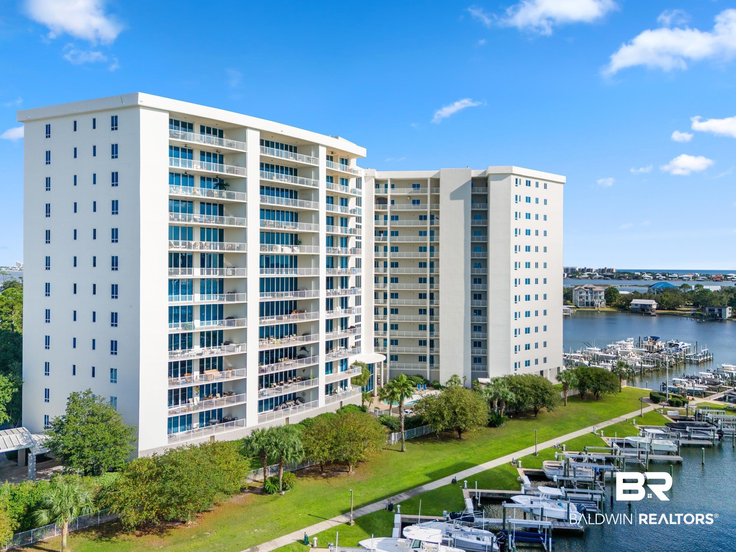 28250 Canal Road, Unit 307 Orange Beach, AL 36561 - Photo 1 of 56 View of apartment building / complex featuring a water view and view of marina