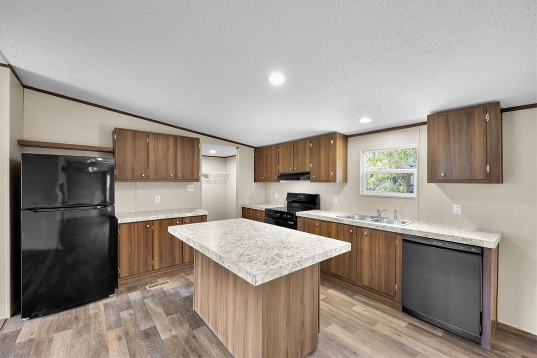 2949 High Shoals Road Anderson, SC 29624 - Photo 4 of 21 This bright kitchen features ample cabinetry, a functional island, and modern appliances.