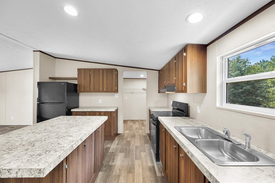 2949 High Shoals Road Anderson, SC 29624 - Photo 6 of 21 This bright kitchen features ample counter space, modern appliances, and a convenient kitchen island.