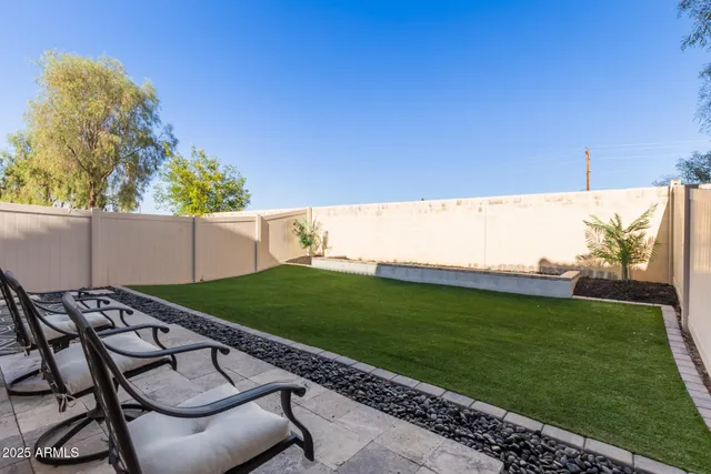 a view of a backyard with furniture