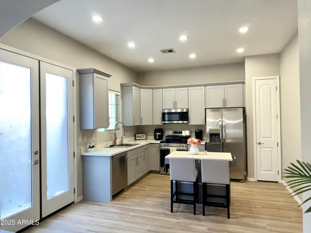 a kitchen with a sink stainless steel appliances and cabinets