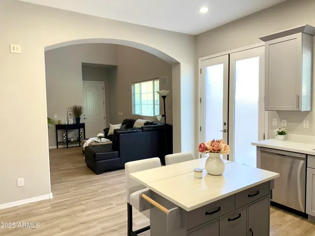 a kitchen with a sink cabinets and wooden floor