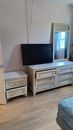 a bedroom with a bed and a dresser