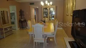 a dining room with furniture and chandelier
