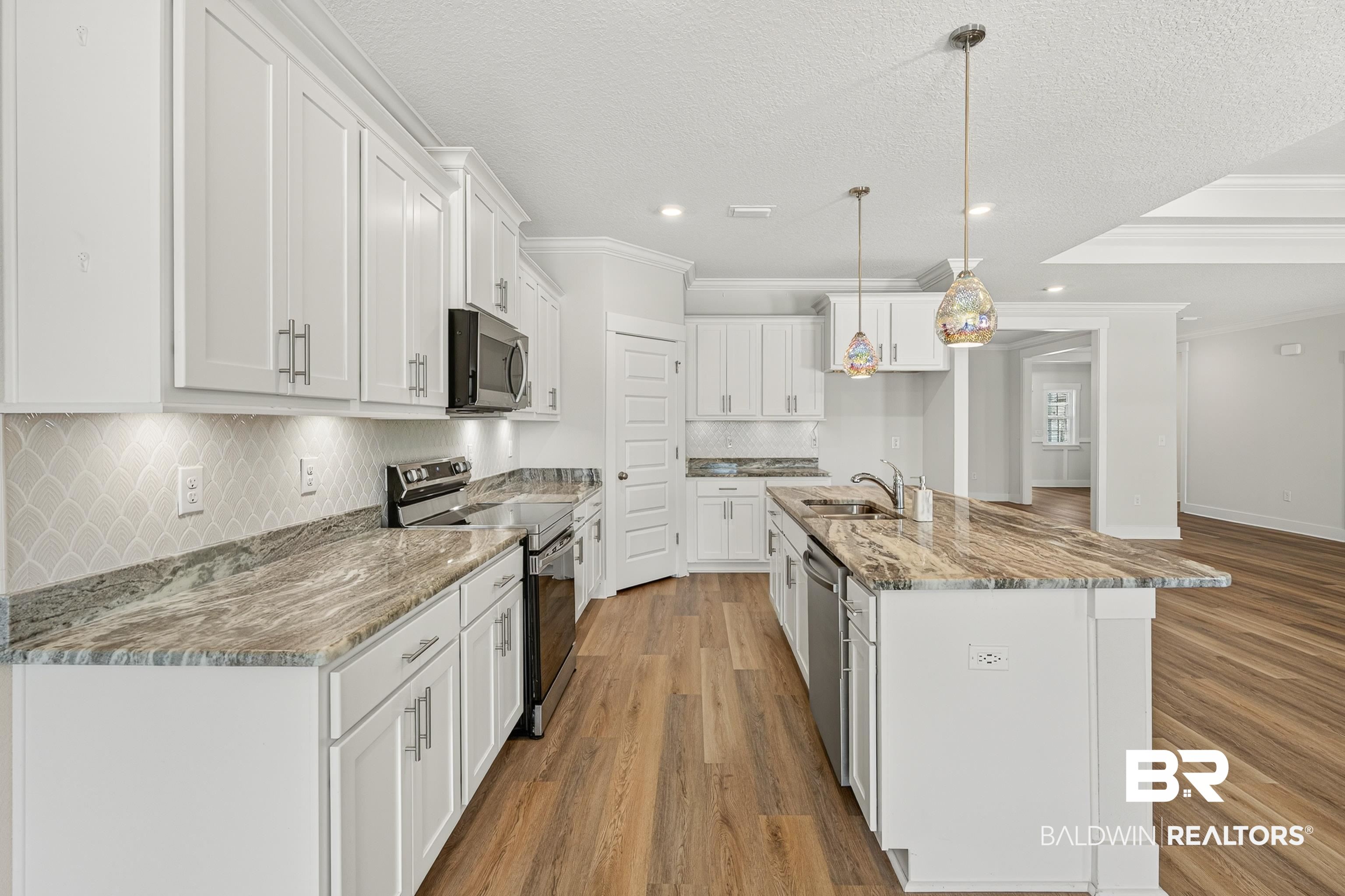 1724 Partridge Street Foley, AL 36535 - Photo 19 of 62 Kitchen featuring white shaker cabinetry and wood-finish flooring