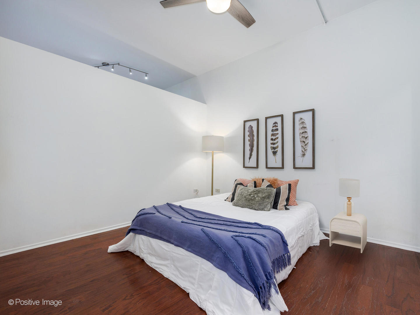 1201 West Adams Street, Unit 608 Chicago, IL 60607 - Photo 11 of 14 a bedroom with a bed and a lamp