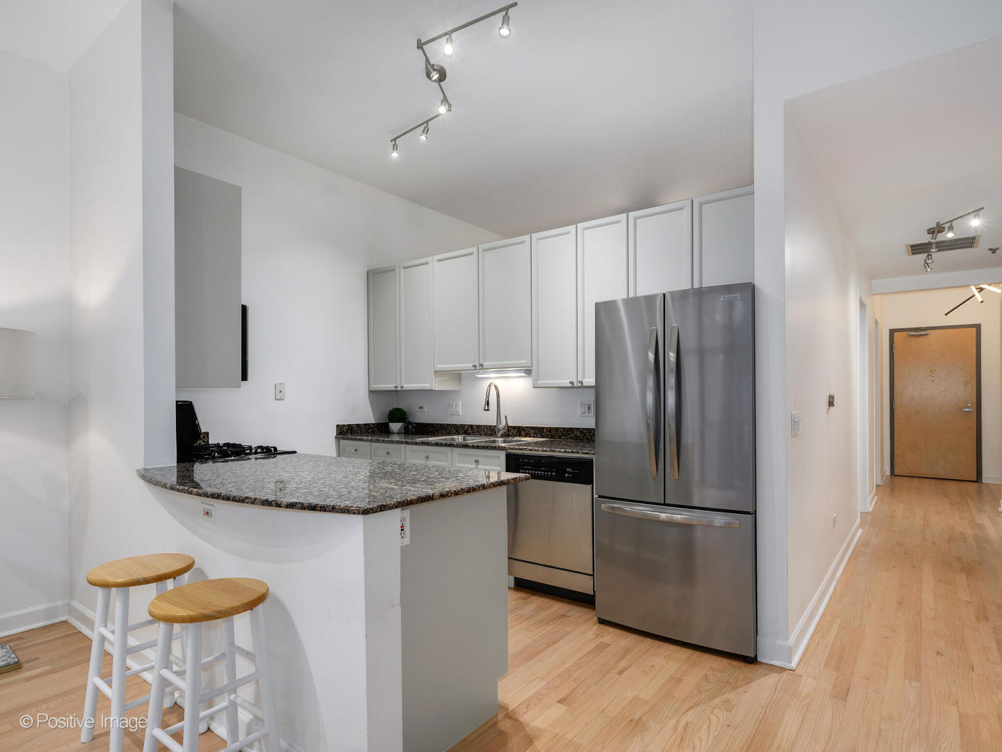 1201 West Adams Street, Unit 608 Chicago, IL 60607 - Photo 5 of 14 a kitchen with stainless steel appliances granite countertop a refrigerator and a stove top oven