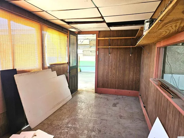 a living room with furniture a flat screen tv and a window