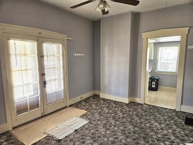 an empty room with a empty space and a ceiling fan