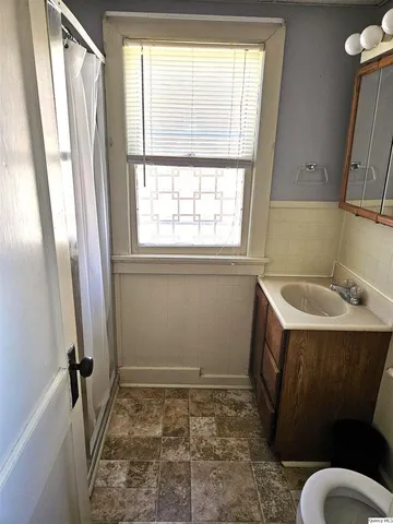 a bedroom with furniture and a window