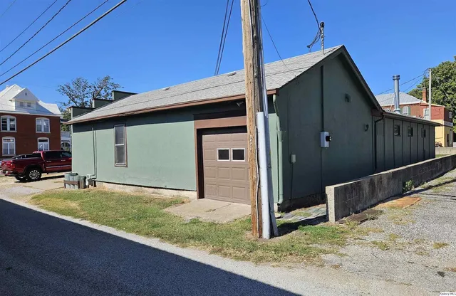 a view of a house with a garden and yard