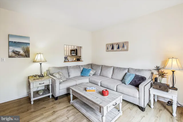 a living room with furniture and a lamp