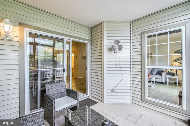 a porch with seating space and glass door