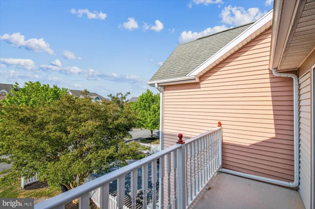 a view of a balcony with wooden fence