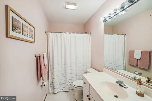 a bathroom with a sink vanity mirror and toilet
