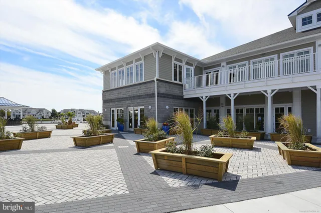 a front view of a building with outdoor seating