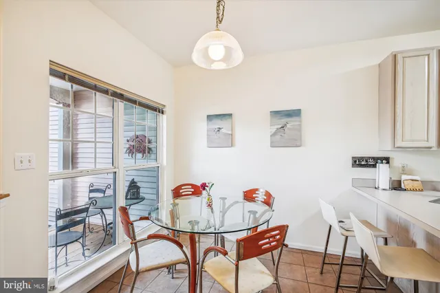 a view of a dining room with furniture and a chandelier