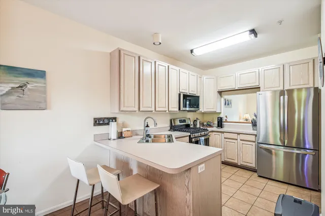 a kitchen with appliances a sink and cabinets