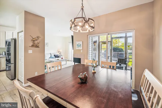 a living room with furniture and floor to ceiling windows