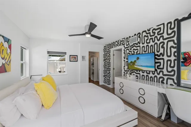 a bedroom with a bed mirror and a window