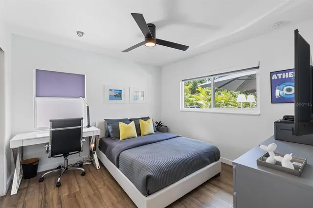 a bedroom with a bed and a desk