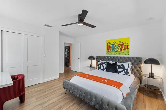 a bedroom with furniture and a ceiling fan