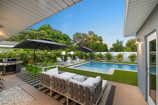 a view of a roof deck with furniture