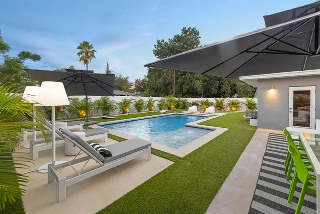 a view of a backyard with sitting area