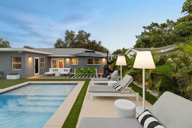 a view of a patio with swimming pool table and chairs