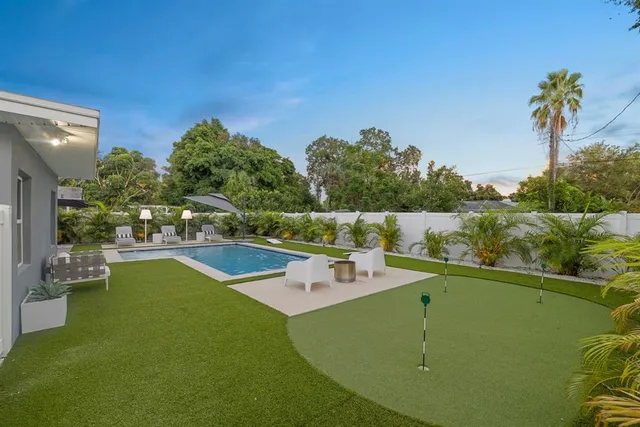 a view of a swimming pool with a yard